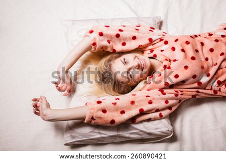morning beautiful girl woke up in bed smiling happy. beautiful blonde woke up in bed, stretching