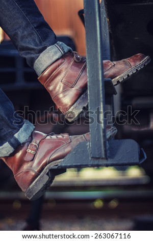 boots on the street close,Ã?Â  style. Men\'s legs with jeans and boots. Hipster at sunset.