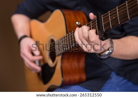playing the guitar. close.