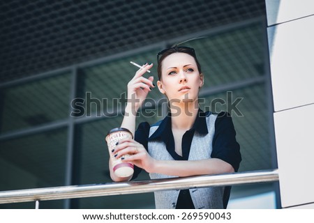 woman smokes on a break, Businesswoman smoking a cigarette in the office