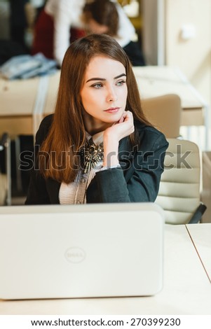 the girl behind the laptop, Business woman relaxing with her hands behind her head and sitting on a chair