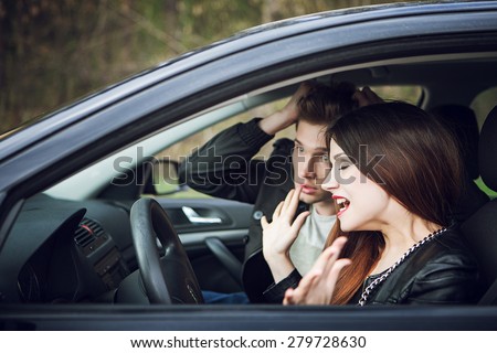 quarrel in the car, the couple quarrel in the car, the woman behind the wheel of a car