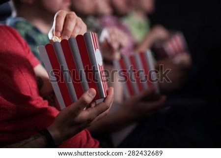 merry company in the cinema,
young people watch movies, film,