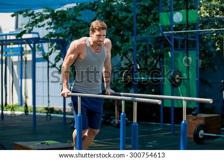 Workout, sportsman pull ups  the horizontal bar