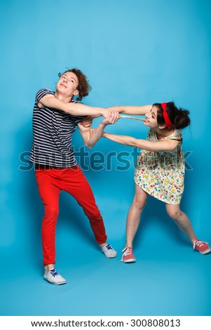 Man and woman fighting for a sweets.