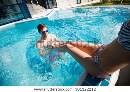 man resting in the pool in the summer