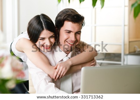 happy young relaxed couple working on laptop computer