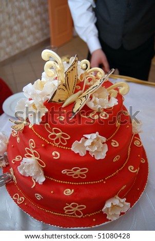 Detail from the groom and bride\'s red cake on the wedding table