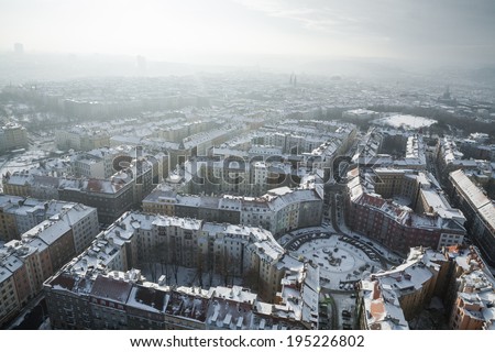 Atmospherics view on blocks of houses with round square in Prague at sunrise