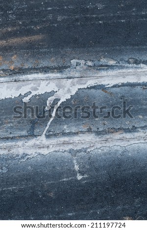 Dark grunge asphalt road texture under construction or under repair. Cutting the road. Abstract background.