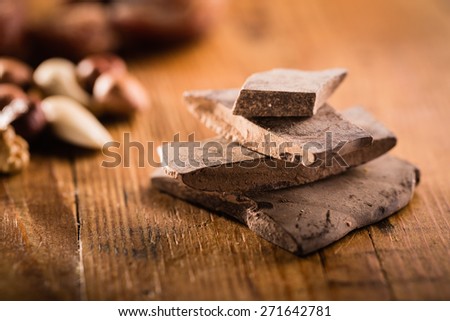Raw cocoa mass on the grunge table or desk in the kitchen. Composition of the ingredients for cooking cakes or ice cream.