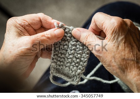 Close up of the old hands knitting. Process of knitting.