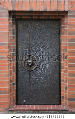 Ornamentally sculpted door of a small public church building.