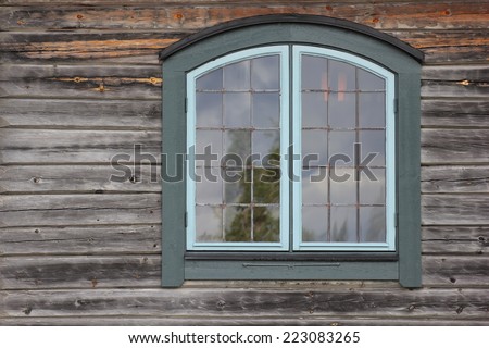 Architectural detail (wall and window) of log house.