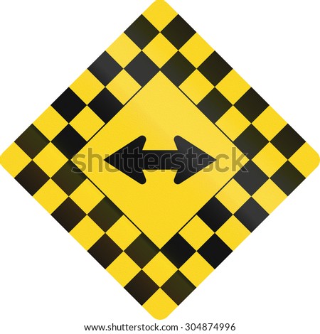 Checked warning road sign in Canada with keep left or right arrow. This sign is used in Ontario.