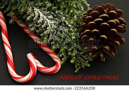 ,,Merry Christmas,, record  on the right, tree,red and white , pinecone in black background view from one side