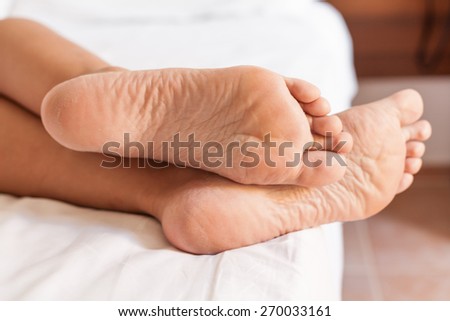 Two feet in a white bed