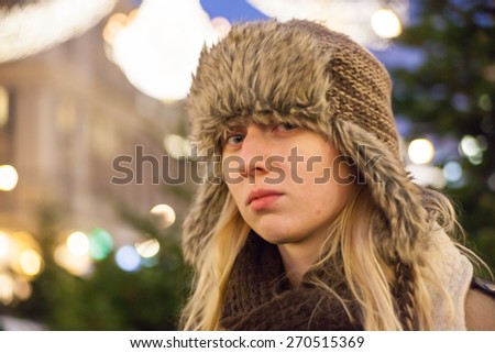 Portrait of blonde girl in hat on the Christmas market in Vienna, Austria