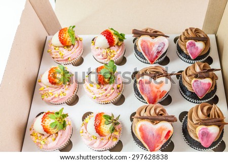 Box with chocolate and strawberry cupcakes for Valentine's Day
