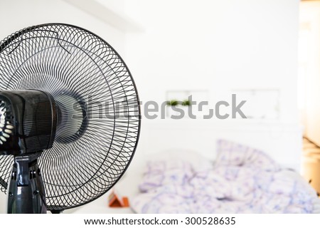 The fan runs in a room in the summer heat