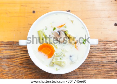 Vegetable milk soup on a wooden background