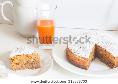 Homemade carrot cake with a glass of carrot juice