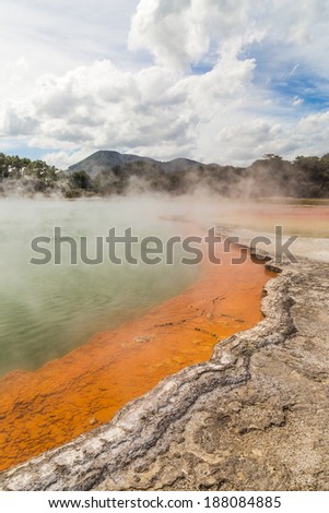 Steam over the colorful Champagne Pool in Wai-O-Tapu geothermal park, Rotorua, New Zealand