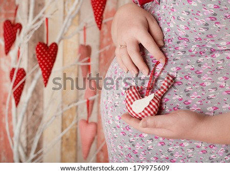 pregnant woman with the bird in hands