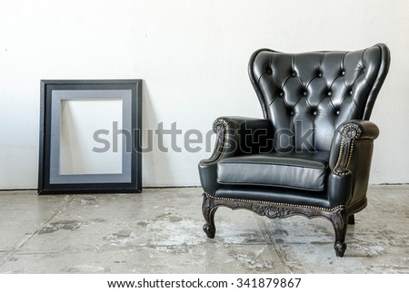 Black genuine leather classical style sofa in vintage room with frame