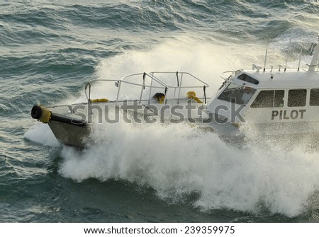 Pilot boat crashing through a wave