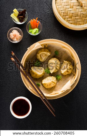 Dim sum dumplings in steamer and ingredients top view
