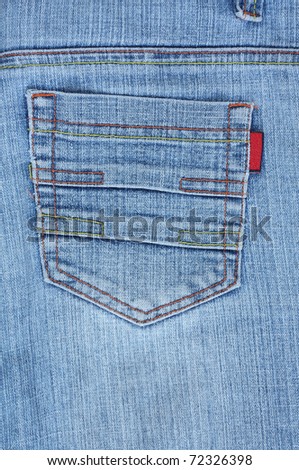 Closeup of back blue jeans pocket with colourful stitches.
