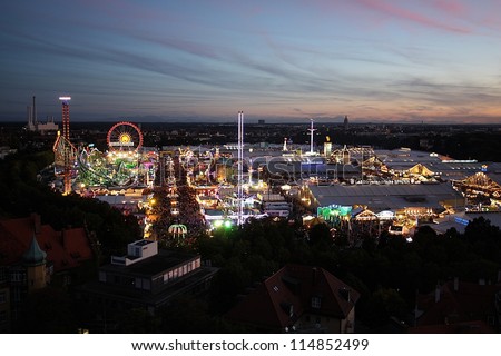 MUNICH - SEPTEMBER 28: The neon lights of the world\'s famous fun fair and beer festival Oktoberfest illuminate the night on September 28, 2012 in Munich, Germany.