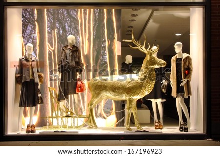 Munich - Dec 8: A Golden Reindeer Dummy Stands In A Fashion Store'S Shop Window Decorated For Christmas On December 8th 2013 In Munich, Germany.