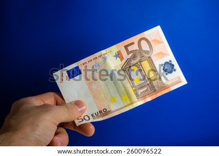 hand give money on a blue background