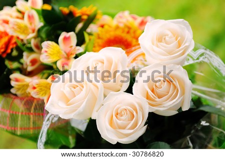 Roses and lilies  are beautiful flowers in a bouquet arrangement.