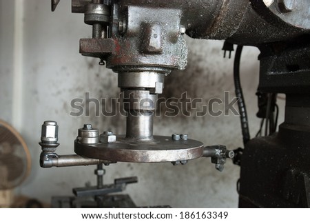 An old industrial electric heavy drill head in a factory for met