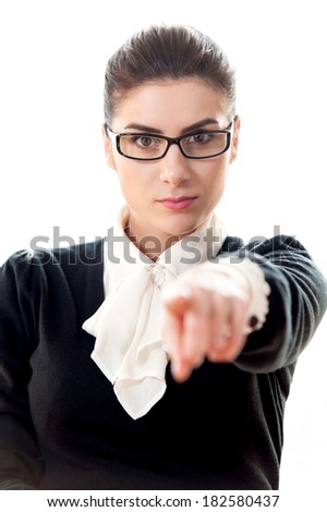 Portrait of a young businesswoman finger pointing on white background
