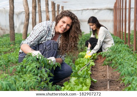 Smiling agriculture woman worker in front and colleague in back