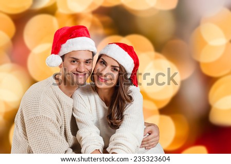 Bright picture of family couple in a winter clothes over isolated christmas colorful lights background
