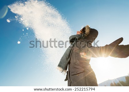 Portrait of cute smiling Happy  woman posing against high snowy mountains