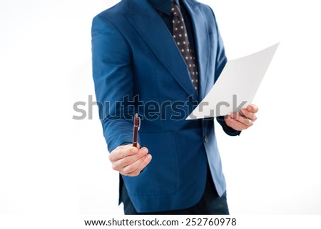 Businessman holding / offering a pen in one hand and a contract in other hand, isolated over white background.