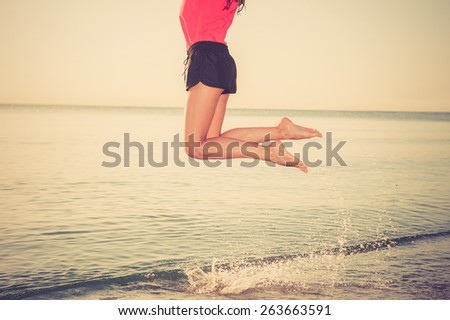 Happy sunshine woman. Joyful girl on warm sunny summer day under the hot sun on beach.