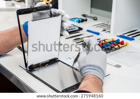 Close-up photos showing process of tablet device repair