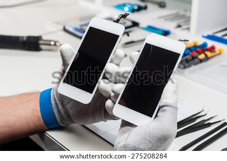 Close-up photos of two mobile phones in a repair atelier.