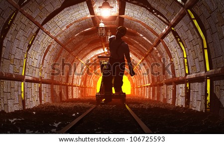 Workers pushing the cart in the mine.