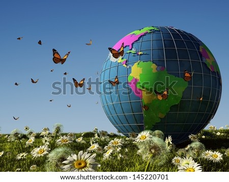 Model of the globe and a butterfly on the grass.