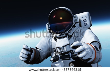 Astronaut in space above the clouds of the Earth.