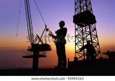 Silhouette of a worker on a background sky