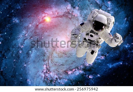 Astronaut spaceman outer space suit galaxy spiral stars. Elements of this image furnished by NASA.
